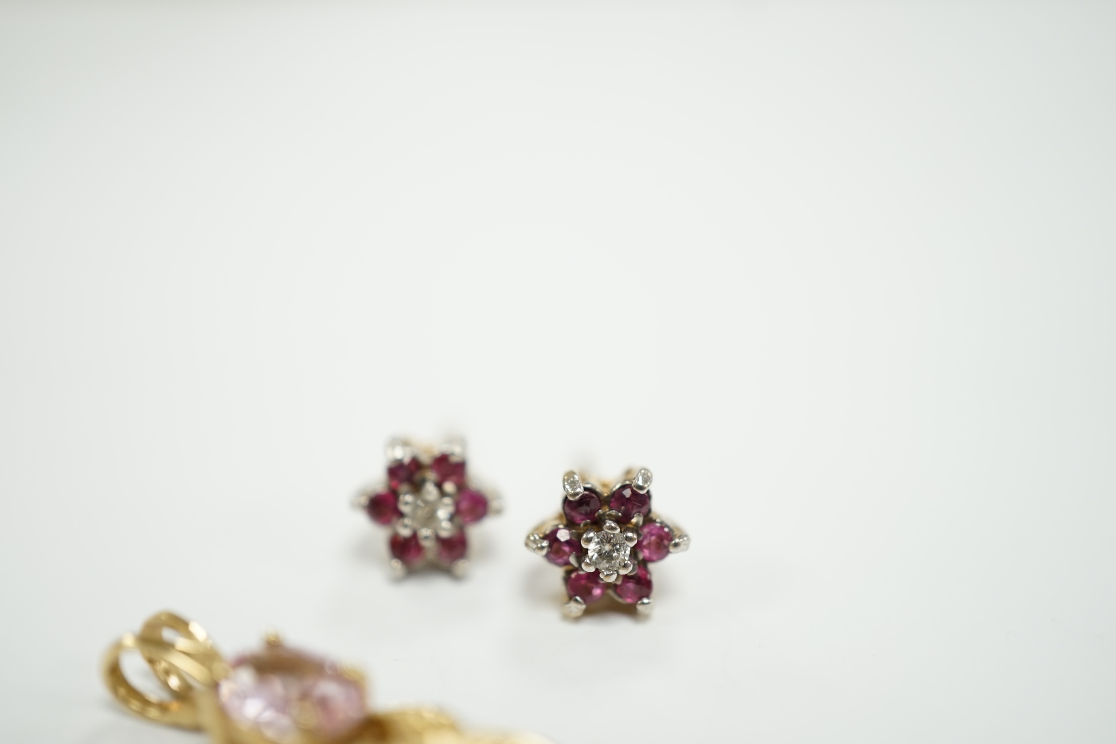 A modern 9ct gold and gem set pendant, 25mm and pair of similar ear studs, gross weight 2.8 grams.